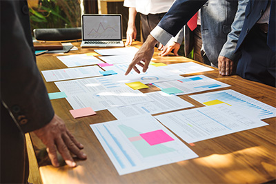 Business group around table with papers spread out