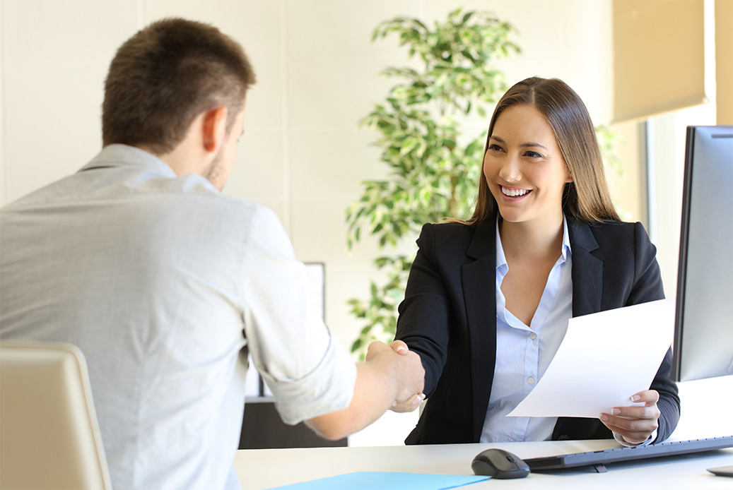 Complete Post man and woman shaking hands over desk