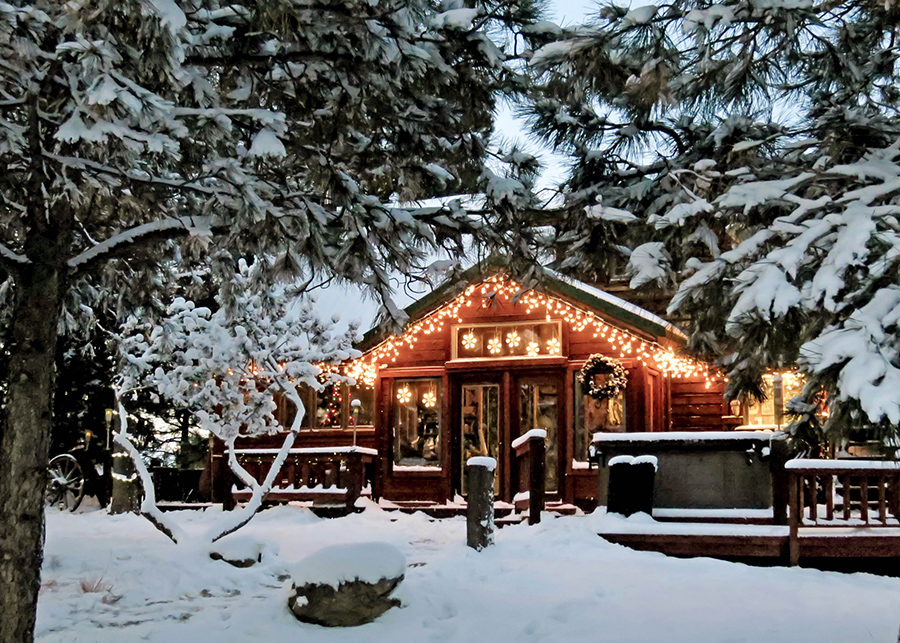 image of house in the winter with snow and holiday lights