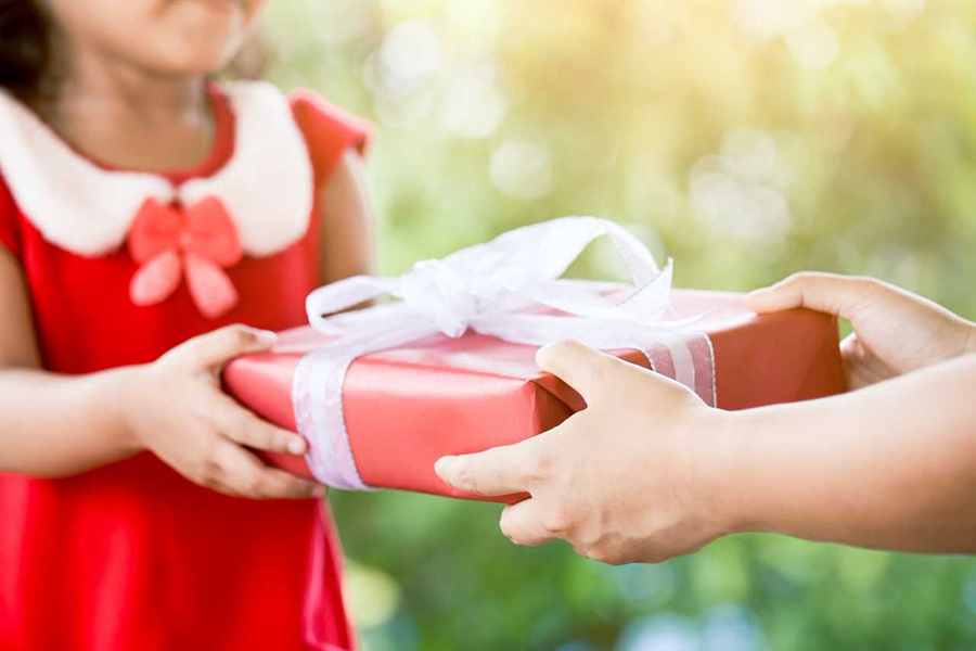 image of child giving/receiving wrapped gift