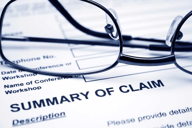 closeup image of claim summary and glasses