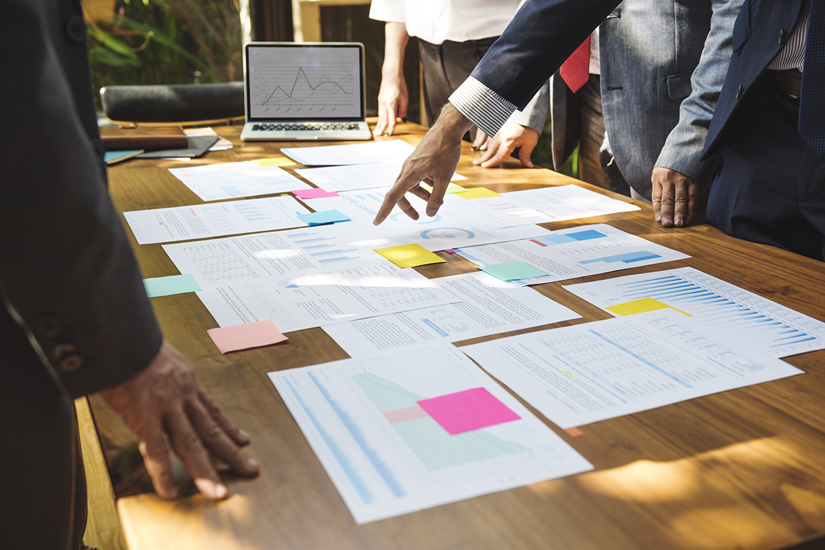 Business Corporate People Working Concept papers on conference table with people showing marketing