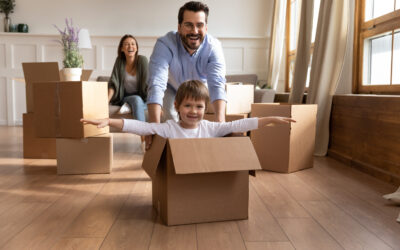 image of young family having fun unpacking