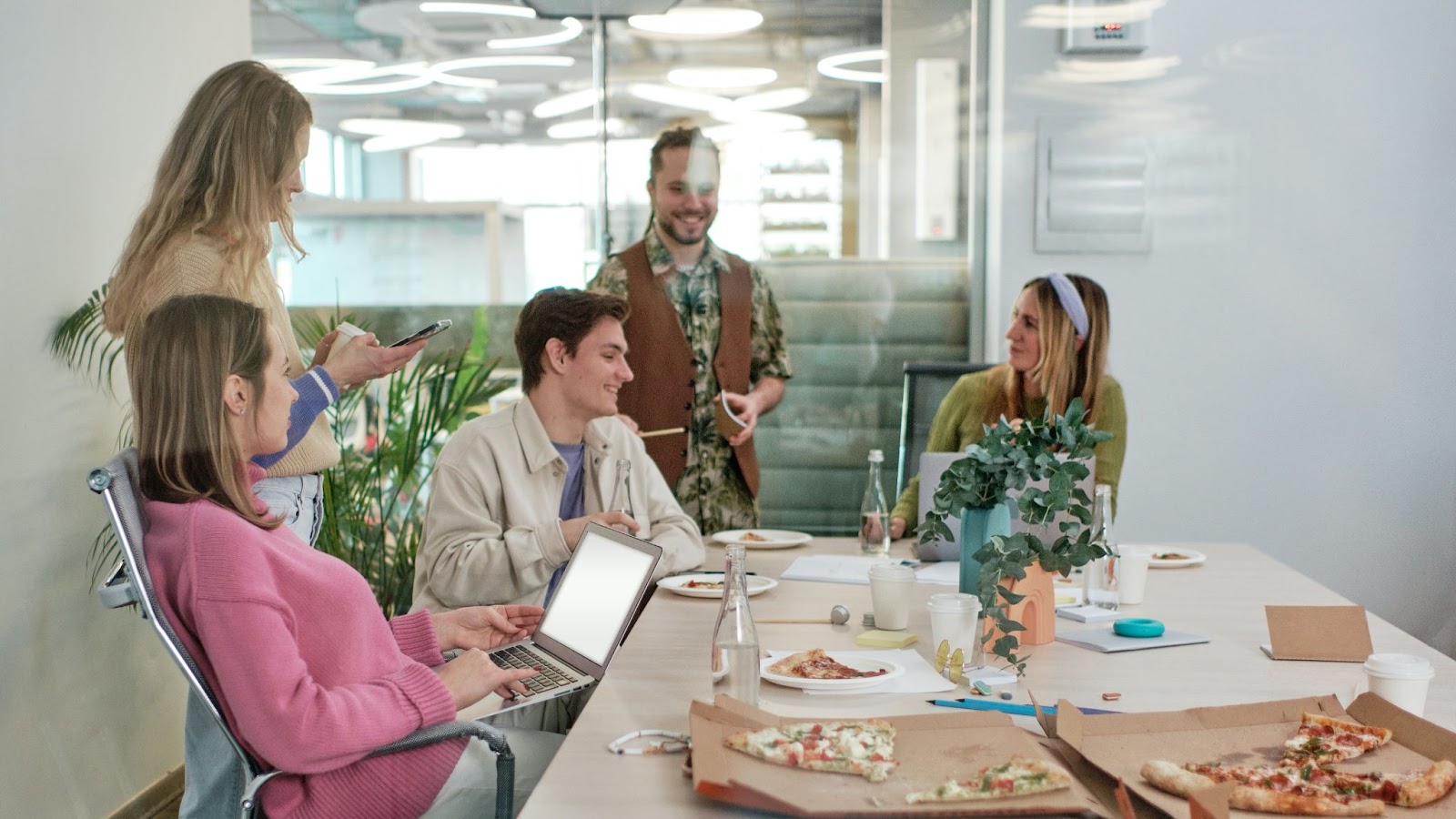 Business people gathered for pizza lunch in office